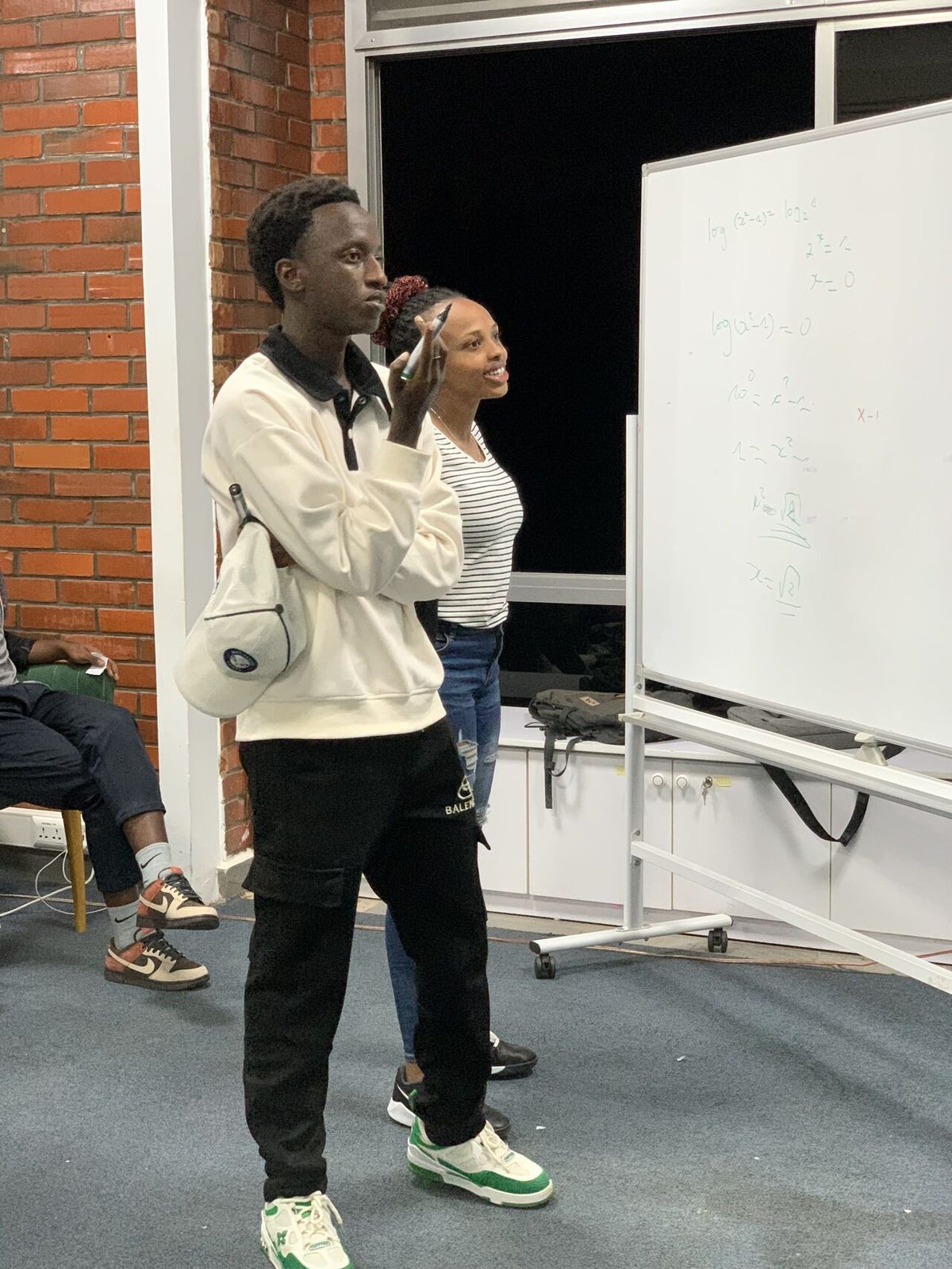 Working through a problem at the board